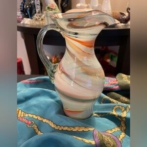 Vintage hand blown art glass swirl pitcher with applied handle.